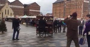 Man playing piano on bike in Gloucester