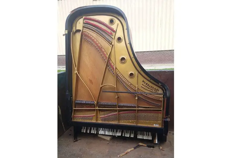 piano in dumpster for waste